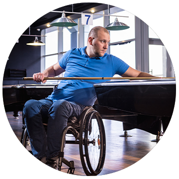 Man in a wheelchair playing snooker or pool